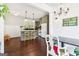 Open concept kitchen and dining area featuring hardwood floors, an island with seating, and bright lighting at 1009 Institute Nw St, Conyers, GA 30012