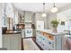 Well-equipped kitchen with an island, gray cabinetry, and stainless steel appliances at 1009 Institute Nw St, Conyers, GA 30012