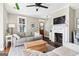Comfortable living room with a fireplace, ceiling fan and hardwood floors at 1009 Institute Nw St, Conyers, GA 30012