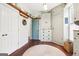 Mud room with lots of custom storage, wood floors, a round rug, and light blue door at 1009 Institute Nw St, Conyers, GA 30012
