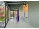 Relaxing screened porch featuring a hanging chair, and clear views of the outdoors at 1009 Institute Nw St, Conyers, GA 30012