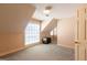 Cozy attic bedroom with dormer window, neutral walls and carpeting and trunk accent at 115 Flagstop Run, Fayetteville, GA 30215