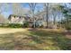 Lush backyard with mature trees, offering ample space for outdoor activities and relaxation at 115 Flagstop Run, Fayetteville, GA 30215