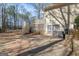 Backyard with wooden deck, stairs, sliding glass door, and a well-manicured landscape at 115 Flagstop Run, Fayetteville, GA 30215