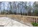 Large backyard with a deck and tall trees at 115 Flagstop Run, Fayetteville, GA 30215