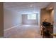 Spacious basement with plush carpet, neutral paint, and natural light from the window at 115 Flagstop Run, Fayetteville, GA 30215