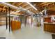 Unfinished basement with ample space and shelving, showcasing the home's potential for storage or a recreational area at 115 Flagstop Run, Fayetteville, GA 30215