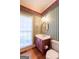 Stylish powder room features a red vanity and a window at 115 Flagstop Run, Fayetteville, GA 30215