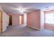 Neutral carpeted bedroom with ceiling fan, natural lighting from windows, and multiple doors at 115 Flagstop Run, Fayetteville, GA 30215