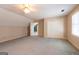 This bonus room features neutral walls, carpet, and a closet with a door and a ceiling fan at 115 Flagstop Run, Fayetteville, GA 30215