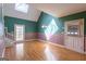Sunlit breakfast nook features skylight, French doors, and hardwood flooring at 115 Flagstop Run, Fayetteville, GA 30215