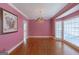 Formal dining area boasts hardwood floors, a bay window, and elegant chandelier at 115 Flagstop Run, Fayetteville, GA 30215