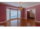 Elegant dining room with hardwood flooring, large windows, and a classic chandelier at 115 Flagstop Run, Fayetteville, GA 30215