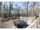 Relax on the spacious exterior deck, featuring a covered hot tub overlooking a wooded backyard at 115 Flagstop Run, Fayetteville, GA 30215