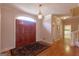 Grand foyer featuring hardwood floors, elegant lighting, and a spacious layout, perfect for welcoming guests at 115 Flagstop Run, Fayetteville, GA 30215