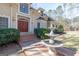 Charming home with a fountain, brick walkway, and lush greenery, creating a welcoming entrance at 115 Flagstop Run, Fayetteville, GA 30215