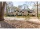 Estate home featuring an expansive lawn, mature trees, and a long driveway with a fountain at 115 Flagstop Run, Fayetteville, GA 30215