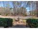 Spacious front yard featuring a three-tiered fountain, well-maintained landscaping, and a charming entrance at 115 Flagstop Run, Fayetteville, GA 30215