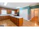 Open kitchen boasts an island, built-in appliances, and plenty of cabinet space at 115 Flagstop Run, Fayetteville, GA 30215