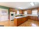 Traditional kitchen with ample counter space, center island, and wood cabinets at 115 Flagstop Run, Fayetteville, GA 30215