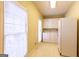 Well-lit laundry room with white appliances and cabinets at 115 Flagstop Run, Fayetteville, GA 30215
