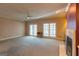 Large living room with a fireplace, neutral carpet, and lots of natural light at 115 Flagstop Run, Fayetteville, GA 30215