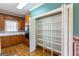 Spacious pantry showcasing built-in shelves, adjacent to a kitchen with oak cabinets at 115 Flagstop Run, Fayetteville, GA 30215