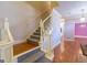 Carpeted staircase with white wooden banister leading to the upper level of the home at 115 Flagstop Run, Fayetteville, GA 30215