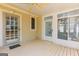 Back porch with tongue and groove decking and multiple entry doors at 115 Flagstop Run, Fayetteville, GA 30215