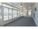 The sunroom features carpet and many windows offering sunlight and views of the yard at 115 Flagstop Run, Fayetteville, GA 30215
