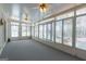 Sunroom has lots of windows, three ceiling fans, and carpet at 115 Flagstop Run, Fayetteville, GA 30215