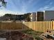View behind fence showing commercial property surrounded by bare dirt lot at 191 Charles Cox Dr, Canton, GA 30115