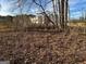Trees surround a new building enclosed by a wood fence in a natural setting at 191 Charles Cox Dr, Canton, GA 30115