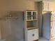 Bright kitchen featuring white cabinets, a refrigerator, and a glass door display cabinet at 191 Charles Cox Dr, Canton, GA 30115