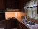 Kitchen featuring wooden cabinets, stainless steel sink, and wood-pattern countertops at 191 Charles Cox Dr, Canton, GA 30115