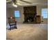 Cozy living room featuring a stone fireplace with a wood mantle and carpet flooring at 191 Charles Cox Dr, Canton, GA 30115