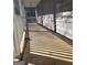 An empty porch with a broom resting along an exterior wall with sunlight streaming through at 191 Charles Cox Dr, Canton, GA 30115