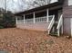Exterior back view of split level home featuring a covered porch with white railings at 191 Charles Cox Dr, Canton, GA 30115