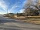 Picture of a lot for sale adjacent to the road and enclosed with a wood fence at 191 Charles Cox Dr, Canton, GA 30115