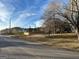 Shot of empty lot for sale by the road, surrounded by a wooden fence at 191 Charles Cox Dr, Canton, GA 30115