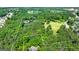Aerial view showcasing the property boundary lines highlighting the surrounding natural landscape and pond at 129 Old Norton Rd, Fayetteville, GA 30215