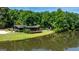 Beautiful lakeside home with a large deck and patio area, surrounded by lush trees and serene waters at 129 Old Norton Rd, Fayetteville, GA 30215