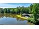 Stunning lakeside home with a deck overlooking the water, surrounded by lush trees and blue sky at 129 Old Norton Rd, Fayetteville, GA 30215