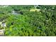 Aerial view featuring a property line showcasing the wooded area, pond, and proximity to neighborhood at 129 Old Norton Rd, Fayetteville, GA 30215