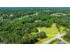 High angle view overlooking lush greenery and canopy of mature trees with scattered homes and a pond at 129 Old Norton Rd, Fayetteville, GA 30215