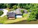 Aerial view of a modern home with an expansive yard, lakeside frontage, deck, and patio at 129 Old Norton Rd, Fayetteville, GA 30215