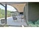 Covered back patio overlooking a serene lake, complete with seating and a modern design at 129 Old Norton Rd, Fayetteville, GA 30215