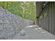 Backyard showing a long stone wall and natural surroundings at 129 Old Norton Rd, Fayetteville, GA 30215