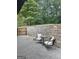 Backyard seating with table showing nature and stone wall surroundings at 129 Old Norton Rd, Fayetteville, GA 30215