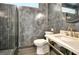 Modern bathroom featuring a gray tiled shower with glass door, and marble vanity at 129 Old Norton Rd, Fayetteville, GA 30215
